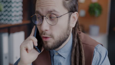 man talking on phone in office
