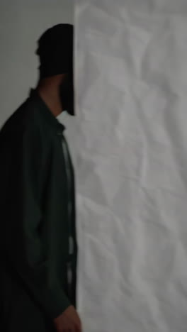 abstract crumpled fabric textures and a person in a dark green jacket