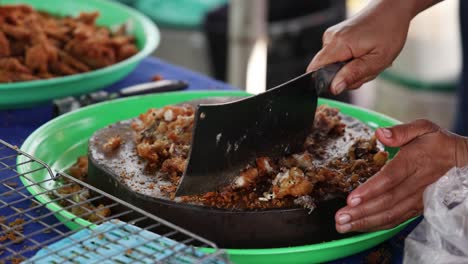 stirring and flipping fried rice in a pan.