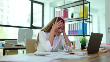 Woman Experiencing Stress or Headache at Work in an Office