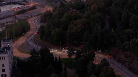trams pass each other on kongsveien, by ekebergsparken, dusk, night
