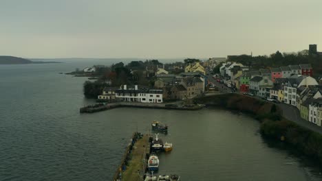 dynamic aerial shot flying over roundstone harbour and main street, connemara