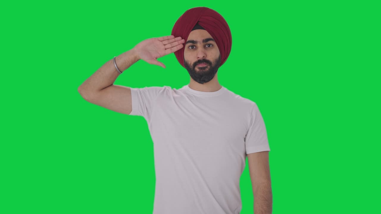 orgulloso hombre indio sikh saludando la pantalla verde