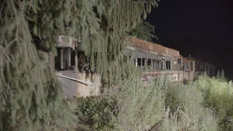 old rotten tram in night forest horror location