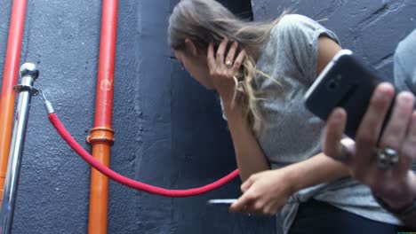 young friends talking and using their phones on steps, 4k 4k