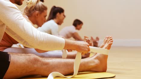 Group-of-people-performing-stretching-exercise-using-resistance-band