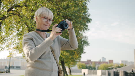senior woman taking photos outdoors