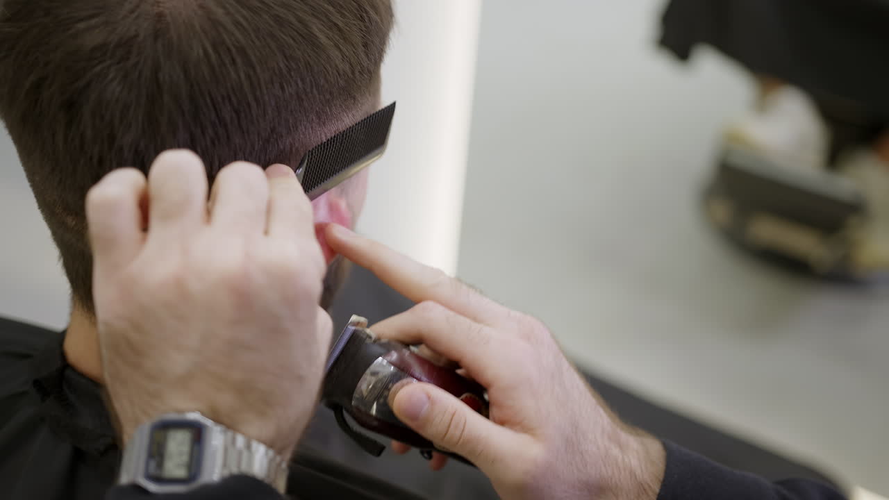 un hombre se corta el cabello en la barbería.
