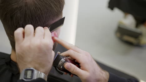 man getting a haircut at the barber shop