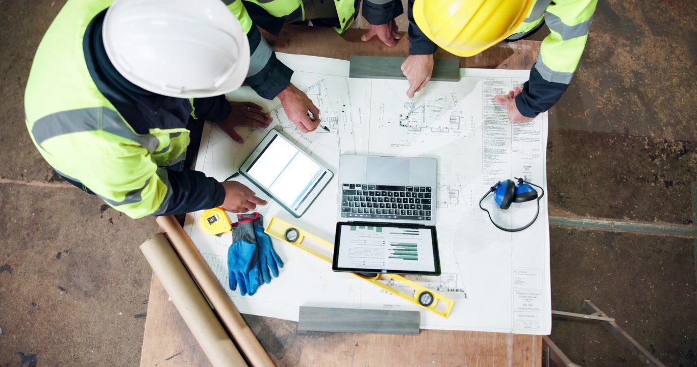 Construction Engineers Reviewing Blueprints and Data on Site
