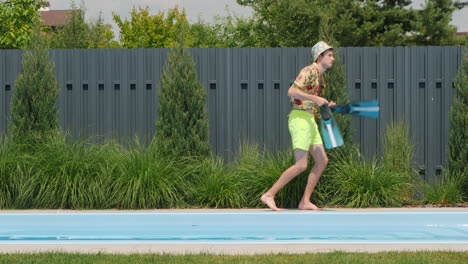 man having fun with flippers near pool