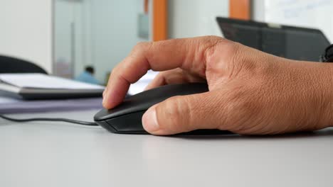 a man hand using black computer mouse