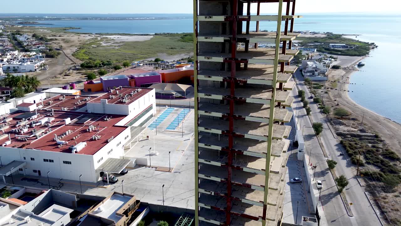 Aerial shot of an abandoned building by the beach.