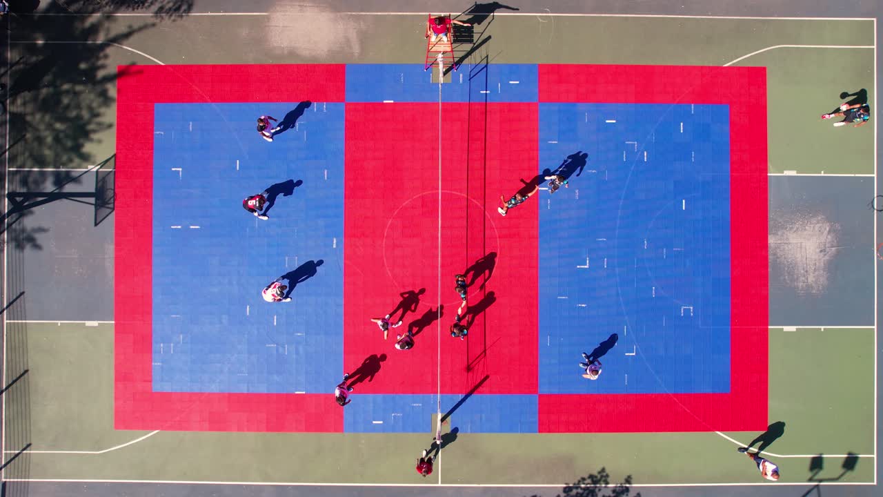 Top Down Aerial View of People Playing Volleyball Game on Colorful Outdoor Court