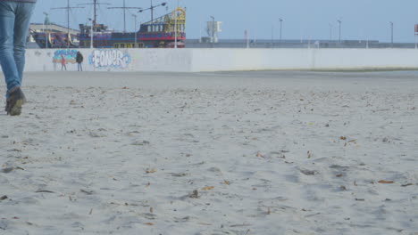 slow motion of people walking on the sandy coast of gdynia in poland. wide