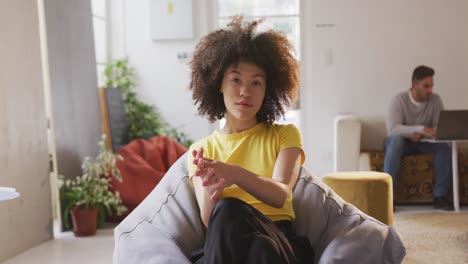 Front-view-of-mixed-race-woman-in-creative-office