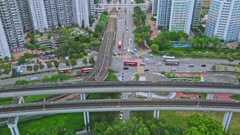 Aerial-time-lapse-of-MTR-Light-Rail-and-Tuen-Ma-Line,-Tin-Shui-Wai,-Hong-Kong