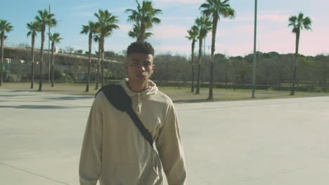 black skater walking in park