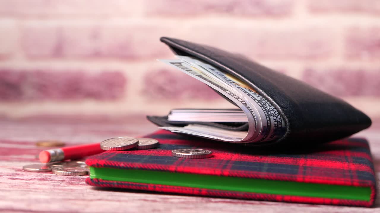 Wallet with Money and Notebook on Wooden Table