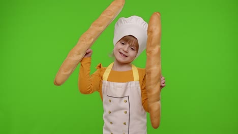 child girl cook chef baker in apron and hat sniffing two baguettes, fooling around, dancing