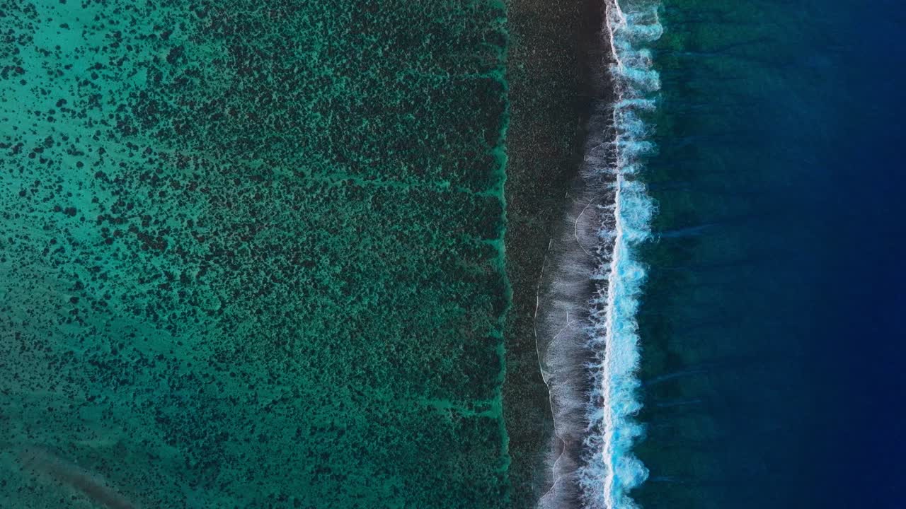 Bora Bora Moorea Mo'orea Tahiti French Polynesia aerial drone birdseye unique birdseye perspective wave surf crashes on coral reef passe channel fingers deep aqua blue South Pacific island static