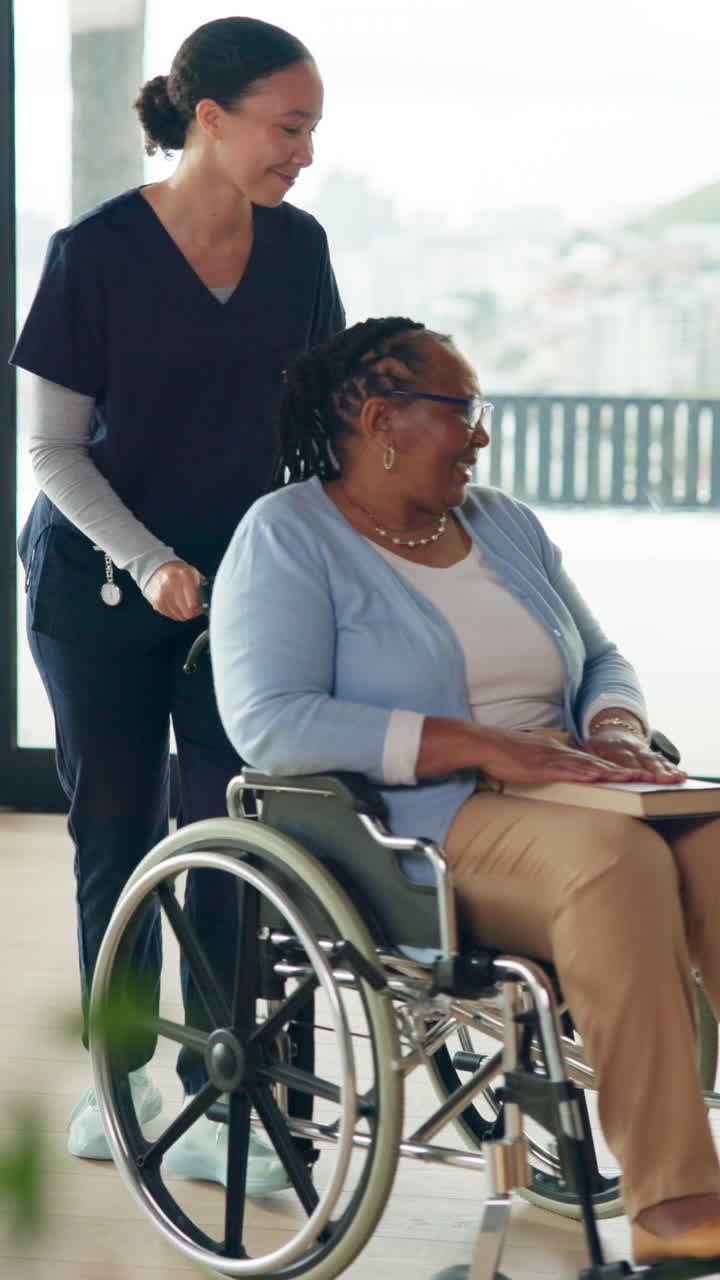 Caregiver Pushing Happy Elderly Woman in Wheelchair While Reading a Book