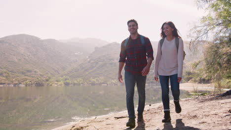 Young-couple-hiking-by-a-mountain-lake