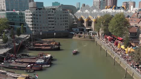 Aerial-footage-of-a-fly-over-of-the-harbor-of-Rotterdam,-Netherlands-where-several-boats-and-barges-are-docked