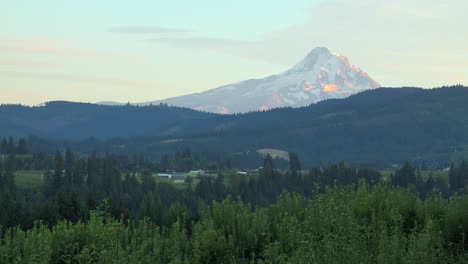 sunset light on mt hood near hood river oregon with farms and fields foreground