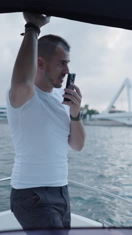 Man on a boat using a mobile phone