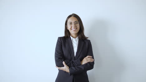 happy successful young businesswoman wearing suit and smiling