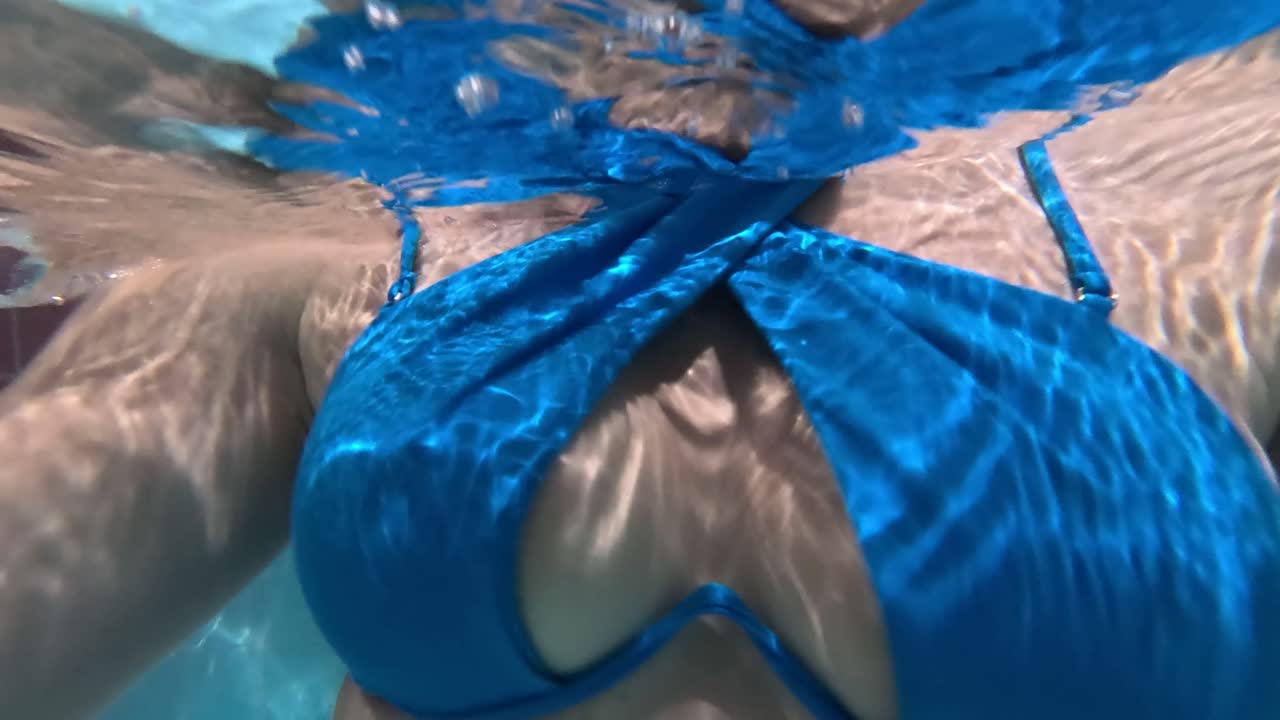 Young Women in the Pool Underwater Shoot. Nice Fit Body With Bikini. Healthy Lifestyle, Active Parents, People Water Sports Activities on Summer Holidays With Child. Water Park