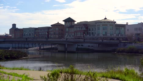 The-Napa-Valley,-Downtown-Napa-static-shot-of-cars-driving-on-a-bridge-infront-of-the-Riverfront