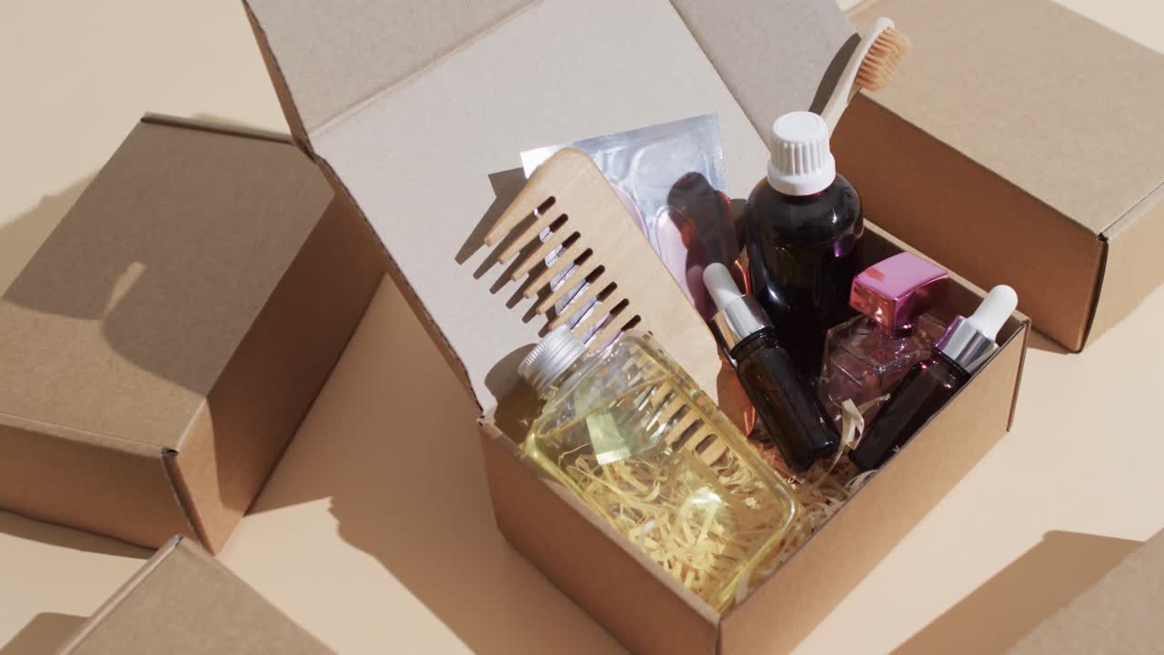 Vertical video of beauty products in cardboard box with boxes and copy space over brown background