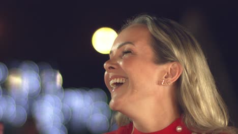 happy, laughing woman with a pretty face at a bar, restaurant or nightclub