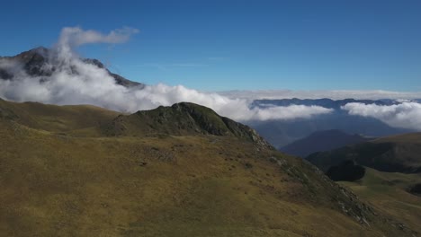 Mountains-shrouded-in-clouds-on-sunny-summer-day,-Col-du-Portet-in-France