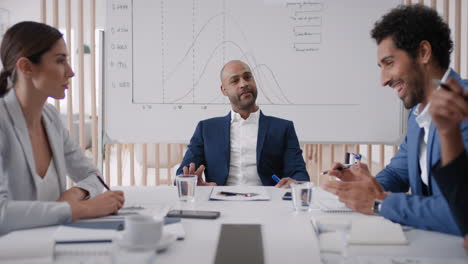 professional businessman team leader meeting with colleagues sharing creative ideas for startup project discussing corporate strategy in office boardroom