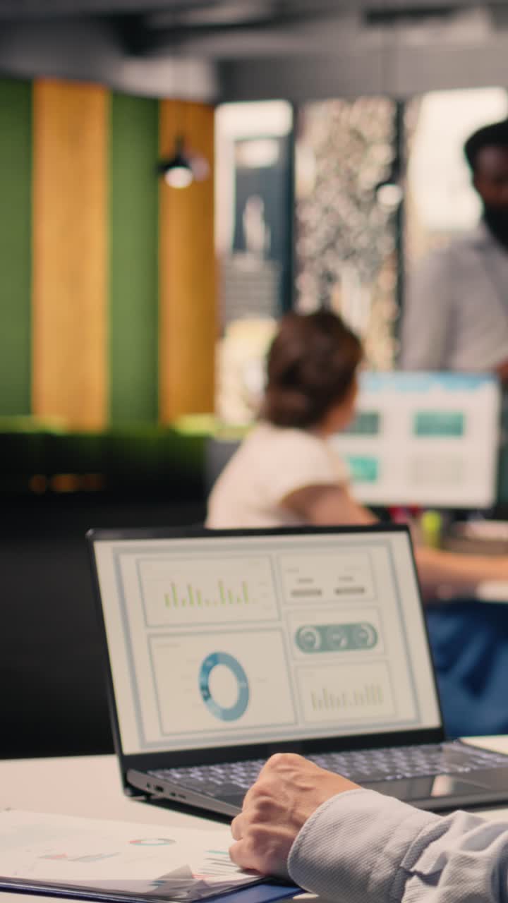 Vertical Video Corporate lifestyle scene with man reviewing KPI metrics and data analysis