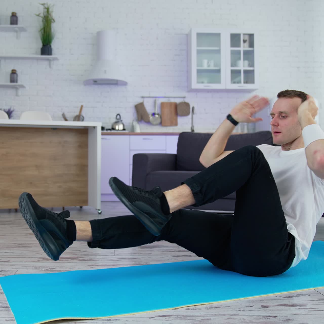 Healthy lifestyle man training his body in home. Strong male working out on quarantine