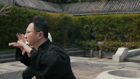 two men practicing tai chi outdoors