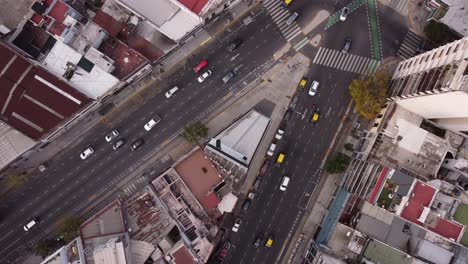 aerial top down view of vehicular traffic on busy roads of cordoba avenue fork in buenos aires, argentina