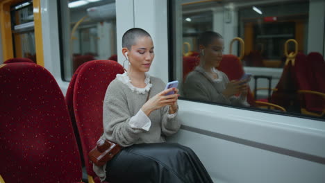 woman using phone on a train