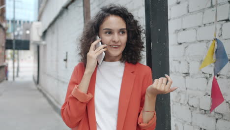 woman talking on phone in urban alley