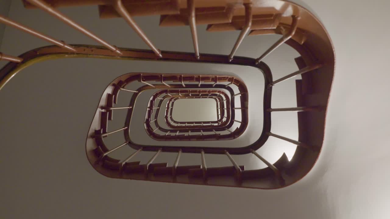 Spiraling staircase viewed from below, emphasizing symmetry and depth