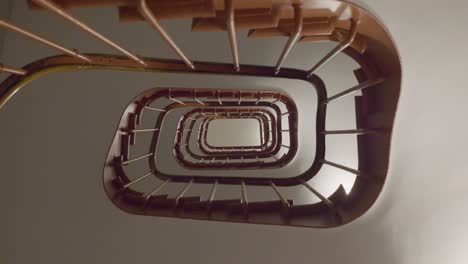 spiraling staircase viewed from below, emphasizing symmetry and depth