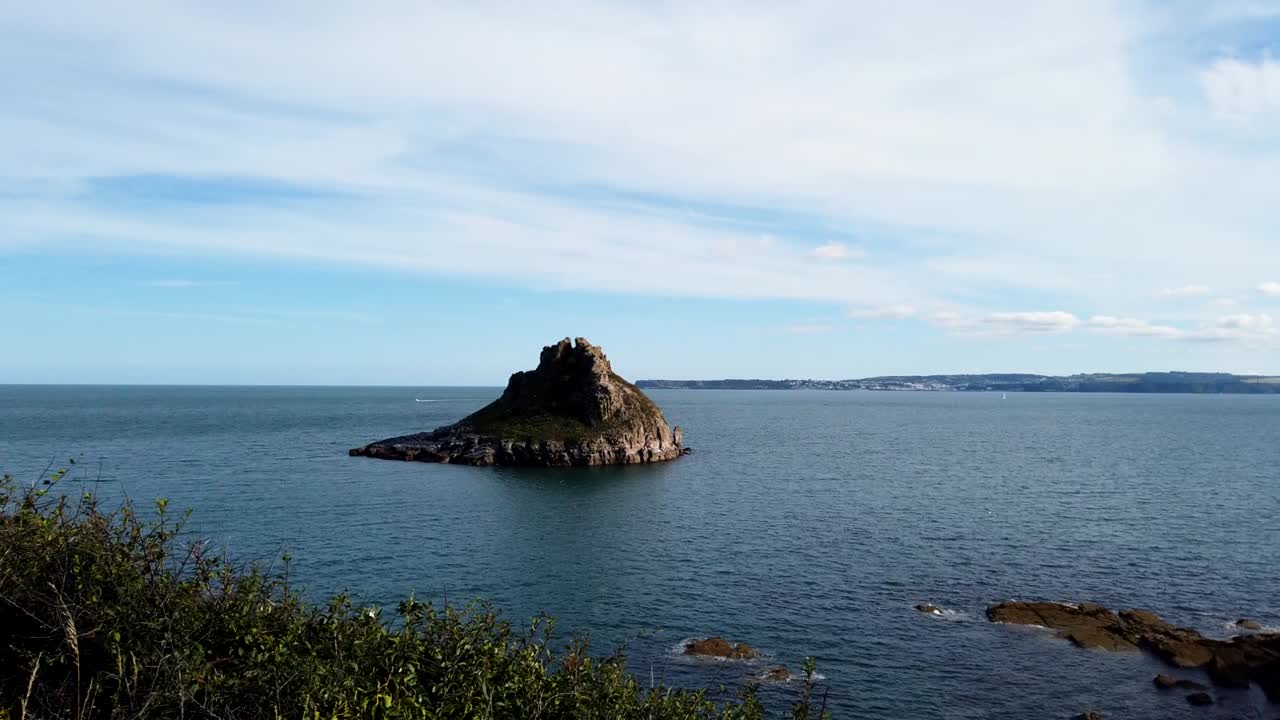 tiro de lapso de tiempo que muestra la roca thatcher en la costa del océano durante el día nublado y soleado