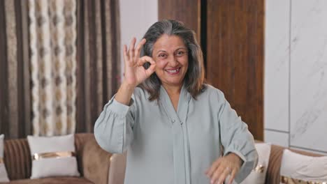 proud indian mother showing okay sign