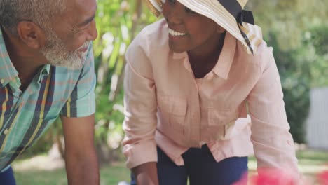 father and daughter gardening during a sunny day