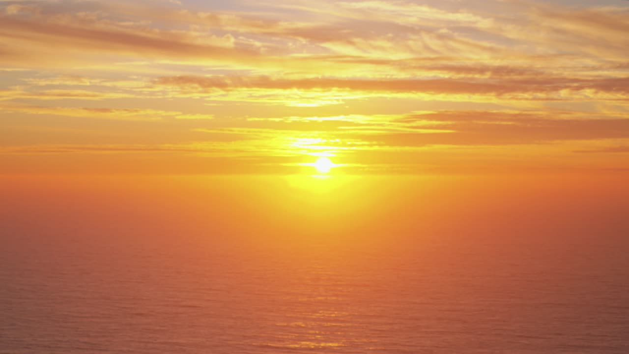 California dreamy vibrant stunning sunset on horizon North Cali San Francisco Point Reyes Bodega Bay Sonoma Coast State Park Pacific Ocean dreamy orange yellows high clouds Big Sur static shot