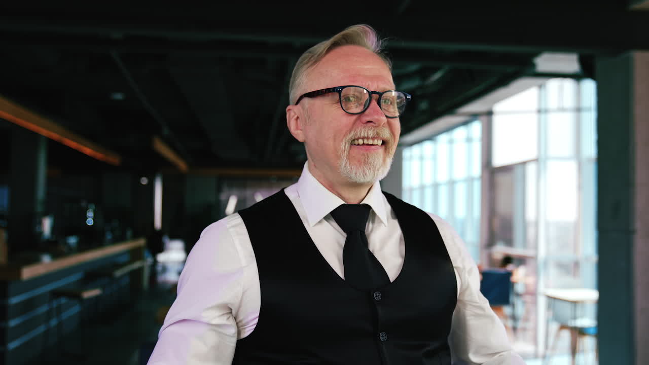 Old Caucasian man having strabismus. Male puts on glasses and rejoices his good eyesight. Close up.